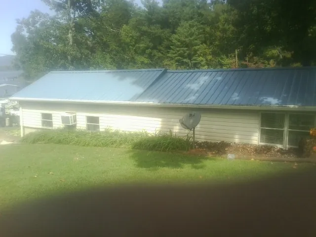 Blue metal roof running the length of a single story home in Wayne